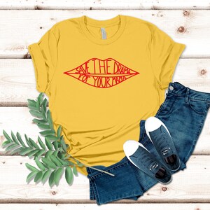 May include: Yellow t-shirt with a red lip design and the text "Save the drama for your mama".