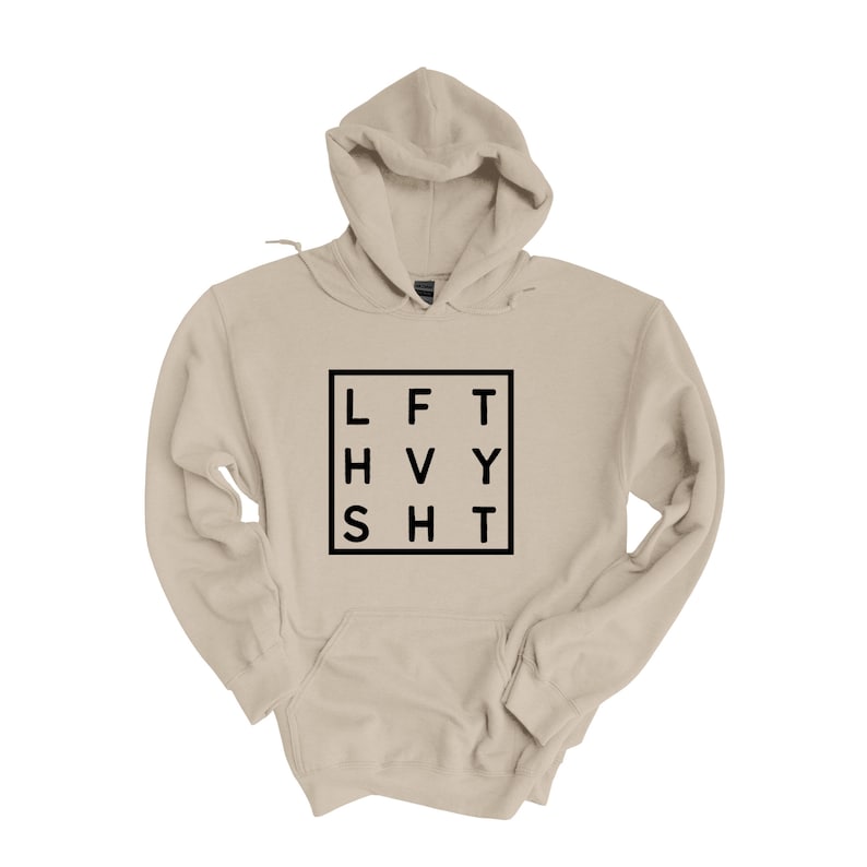 May include: A beige hooded sweatshirt with a black square graphic that says "LFT HVY SHT" in a grid pattern.
