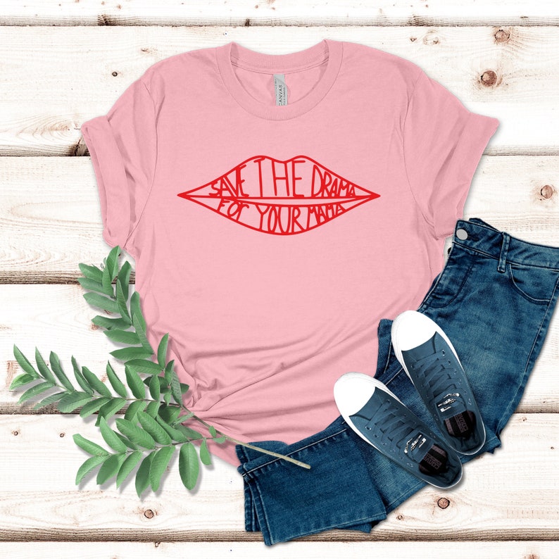 May include: Pink t-shirt with a red outline of a mouth with the text "Save the drama for your mama" inside.