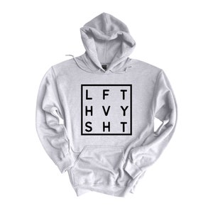 May include: A gray hooded sweatshirt with a black square graphic that says "LFT HVY SHT" in a block font.