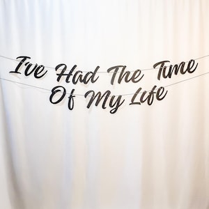 May include: Black and white banner with the text "I've Had The Time Of My Life" hanging on a white background.