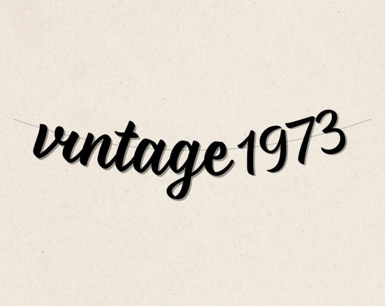 May include: Black and white banner with the text "vintage 1973" in a cursive font.
