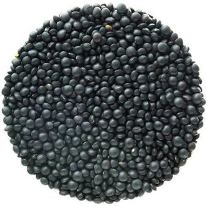May include: A close-up view of black lentils, a type of legume, filling the entire frame. The lentils are small, round, and have a matte finish.