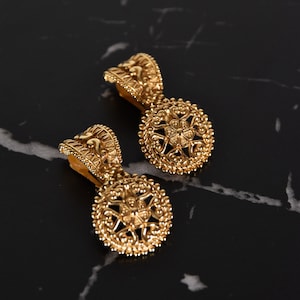 CHRISTIAN DIOR clip-on earrings, gold ovoid and circular design dangle earrings adorned with floral & heart motifs.