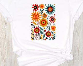 May include: White t-shirt with a colorful floral design featuring red, yellow, orange, green, and blue flowers.