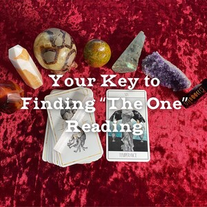 May include: A collection of crystals and tarot cards arranged on a red velvet surface. The text "Your Key to Finding 'The One' Reading" is displayed. The tarot card "Temperance" is visible.