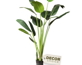 May include: A green artificial bird of paradise plant in a black pot with a brown tag that says "DECOR CHOICE".