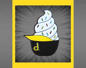 May include: A white and yellow enamel pin of a swirl of ice cream with sprinkles in a black cup with a yellow brimmed hat and the letter "D" on the front.