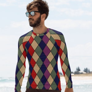May include: A long-sleeved shirt with a geometric diamond pattern in shades of red, green, blue, purple, and beige.