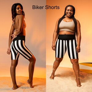 May include: Two people wearing black and white striped biker shorts. The shorts have a high waist and are made of a stretchy fabric. The text "Biker Shorts" is displayed at the top of the image.