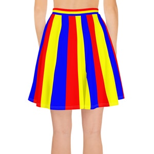 May include: A short, pleated skirt with vertical stripes in red, yellow, and blue.