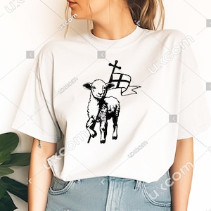 May include: White t-shirt with a black and white graphic of a lamb carrying a cross and a flag. The lamb is standing on a stick.