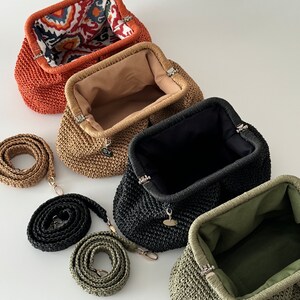 May include: Four woven straw purses with different colored linings and matching straps. The purses are lined with orange, beige, black, and green fabric. The straps are orange, beige, black, and green.