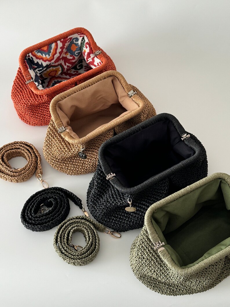 May include: Four woven straw purses with different colored linings and matching straps. The purses are lined with orange, beige, black, and green fabric. The straps are orange, beige, black, and green.