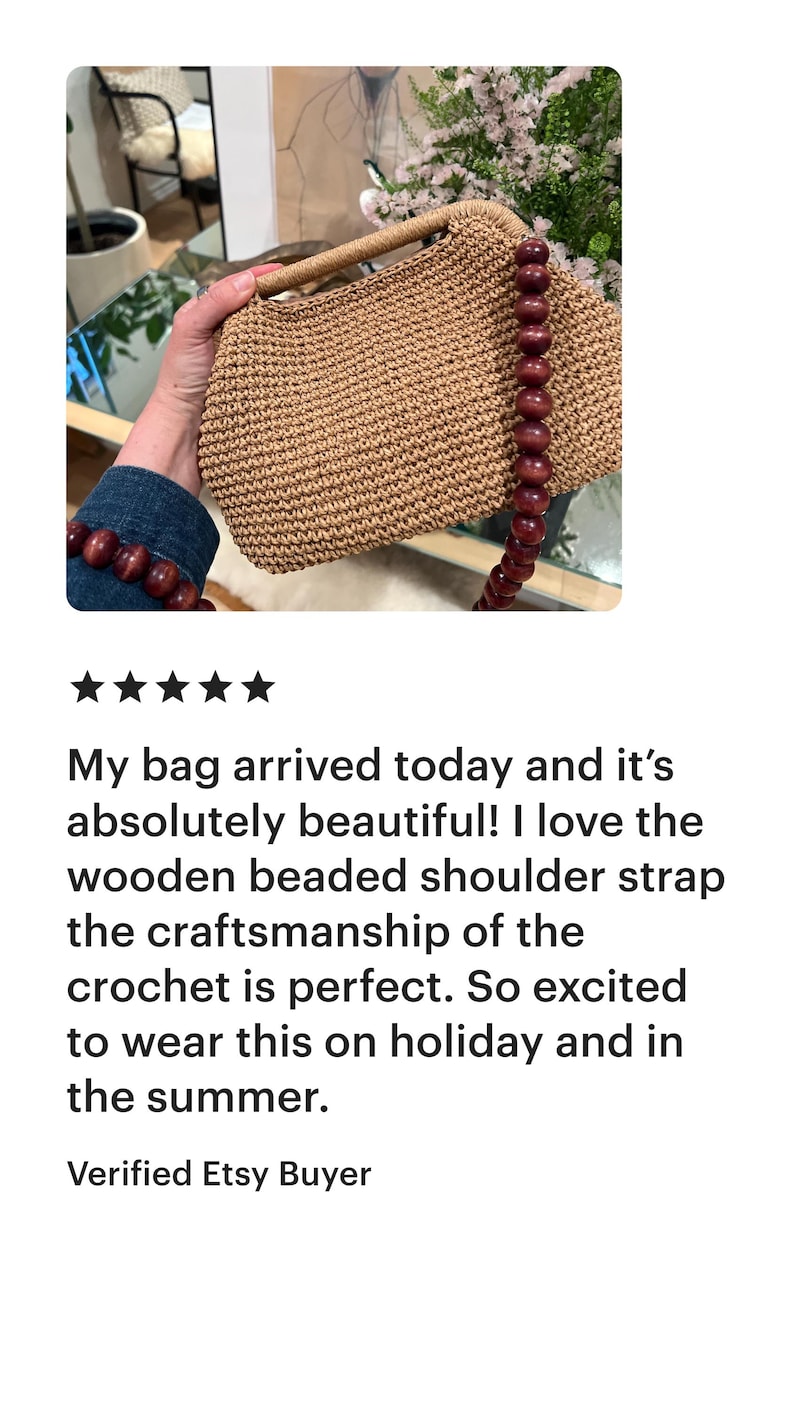 May include: A crocheted handbag with a wooden beaded shoulder strap and handle. The bag is a light brown color and has a rectangular shape. The bag is held by a person.
