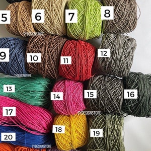 May include: A collection of colorful twine balls, numbered 1-23, in various shades including black, white, beige, green, brown, blue, red, pink, yellow, and orange. The text "SYDESIGNSTORE" is visible on the image.