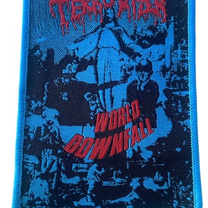 May include: A blue and black woven patch with the text "TERRORIZER" in red dripping letters and "WORLD DOWNFALL" in red letters. The patch features a black and white image of a band.