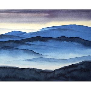 May include: Watercolour painting of a blue mountain range with a hazy, misty atmosphere. The mountains are layered in shades of blue, creating a sense of depth and distance.