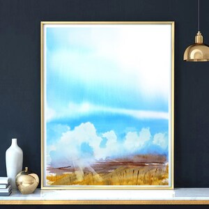 May include: A watercolor painting of a landscape with a blue sky and white clouds. The foreground is a field of tall grass with a brown and green color scheme.