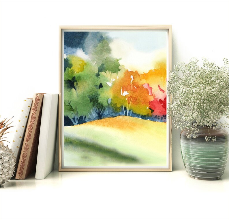May include: Watercolor painting of a landscape with trees in shades of green, yellow, orange, and red. The trees are in the background with a grassy field in the foreground.