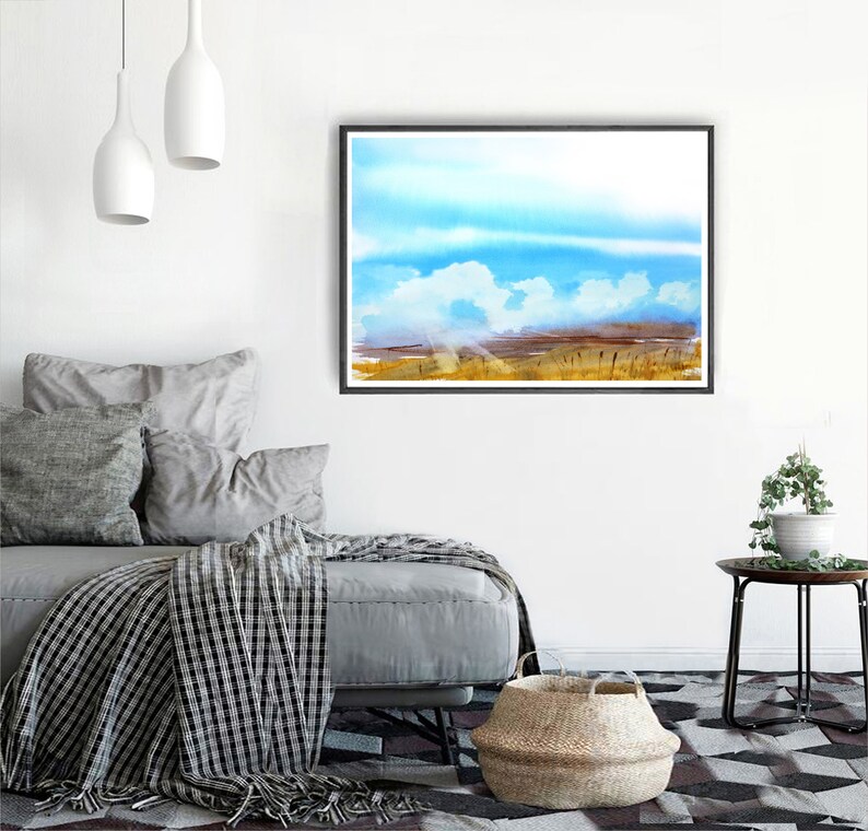 May include: A watercolor painting of a landscape with a blue sky and white clouds. The foreground is a field of tall grass in shades of brown and yellow.