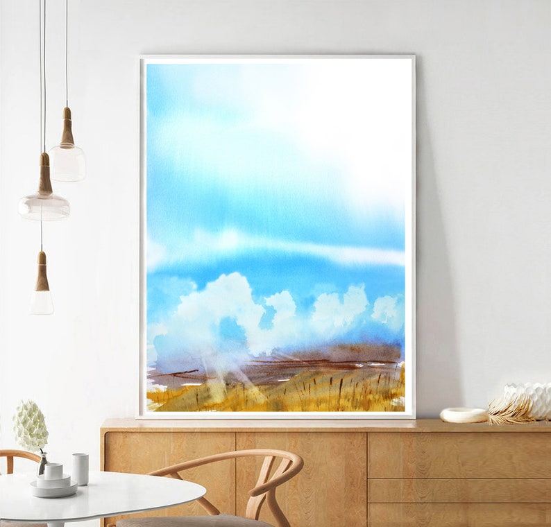 May include: A watercolor painting of a landscape with a blue sky and white clouds. The landscape is a field of tall grass with a few trees in the distance. The sun is shining brightly and the sky is a light blue.