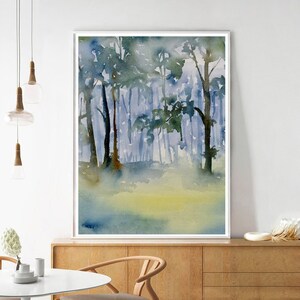May include: A watercolor painting of a forest scene with tall trees and a misty background. The trees are painted in shades of blue and green, and the mist is a soft, pale blue. The painting has a calming and serene atmosphere.