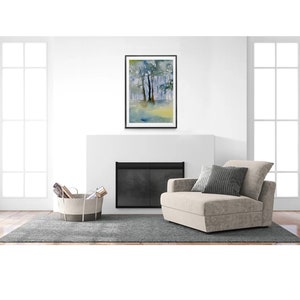 May include: A framed watercolor painting of a forest scene with trees and a blue sky. The painting is in a black frame and is hanging on a white wall above a fireplace.