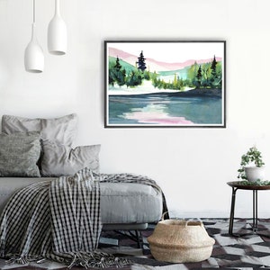 Pode incluir: Uma pintura a aquarela de uma cena de lago com uma floresta no fundo. O lago &eacute; de cor azul claro com um reflexo rosa do c&eacute;u. A floresta &eacute; de cor verde escura com algumas &aacute;rvores em primeiro plano. A pintura &eacute; emoldurada em uma moldura preta.
