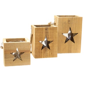 Könnte beinhalten: Drei Kerzenhalter aus Holz mit Sternenausschnitten. Die Halter sind in verschiedenen Größen und aus Naturholz gefertigt.