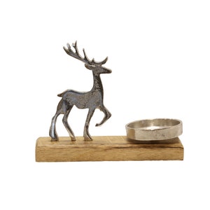 May include: Silver reindeer candle holder with a wooden base and a silver candle dish.
