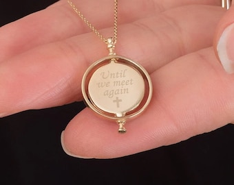 May include: Gold necklace with a spinning pendant that reads "Until we meet again" with a small cross on the back.