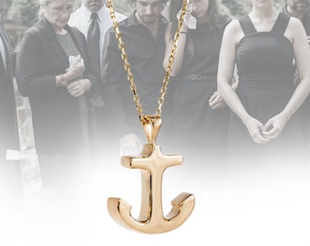 May include: A gold anchor pendant necklace with a delicate chain. The pendant is a simple, classic design with a smooth finish.