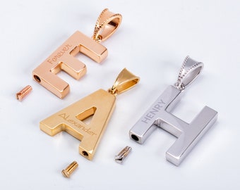May include: Gold, rose gold, and silver charm pendants with screw-on closures. The pendants are shaped like the letters 'F', 'A', and 'H' and have the words 'Forever', 'Alexander', and 'Henry' engraved on them. The charms are available in 14 karat and 18 karat gold.