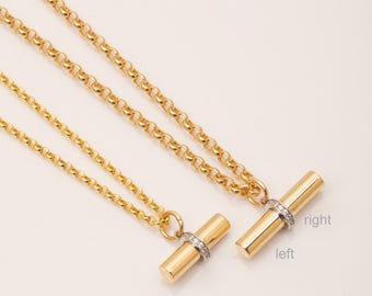 May include: Two gold necklaces with a bar pendant featuring a row of small diamonds. The pendant on the left necklace is smaller than the pendant on the right necklace. The text "left" and "right" is written below the pendants.