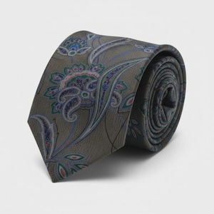 May include: Rolled-up tie with a floral paisley pattern. The tie features a muted olive-green background with a repeating design of blue, pink, and green floral elements. The tie is made of a smooth fabric and is suitable for formal occasions.