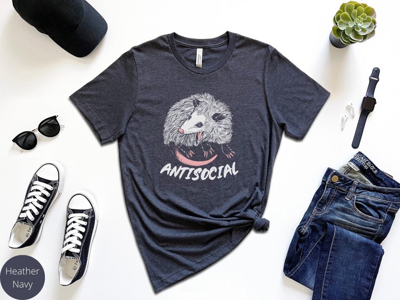 May include: A heather navy t-shirt with a graphic of a possum and the text "ANTISOCIAL".