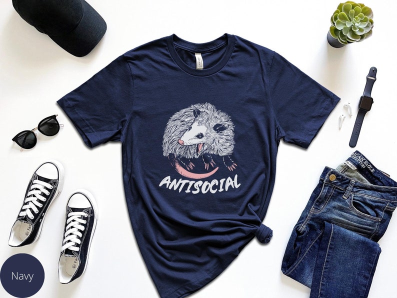 May include: A navy blue t-shirt with a graphic of a possum and the text "Antisocial".