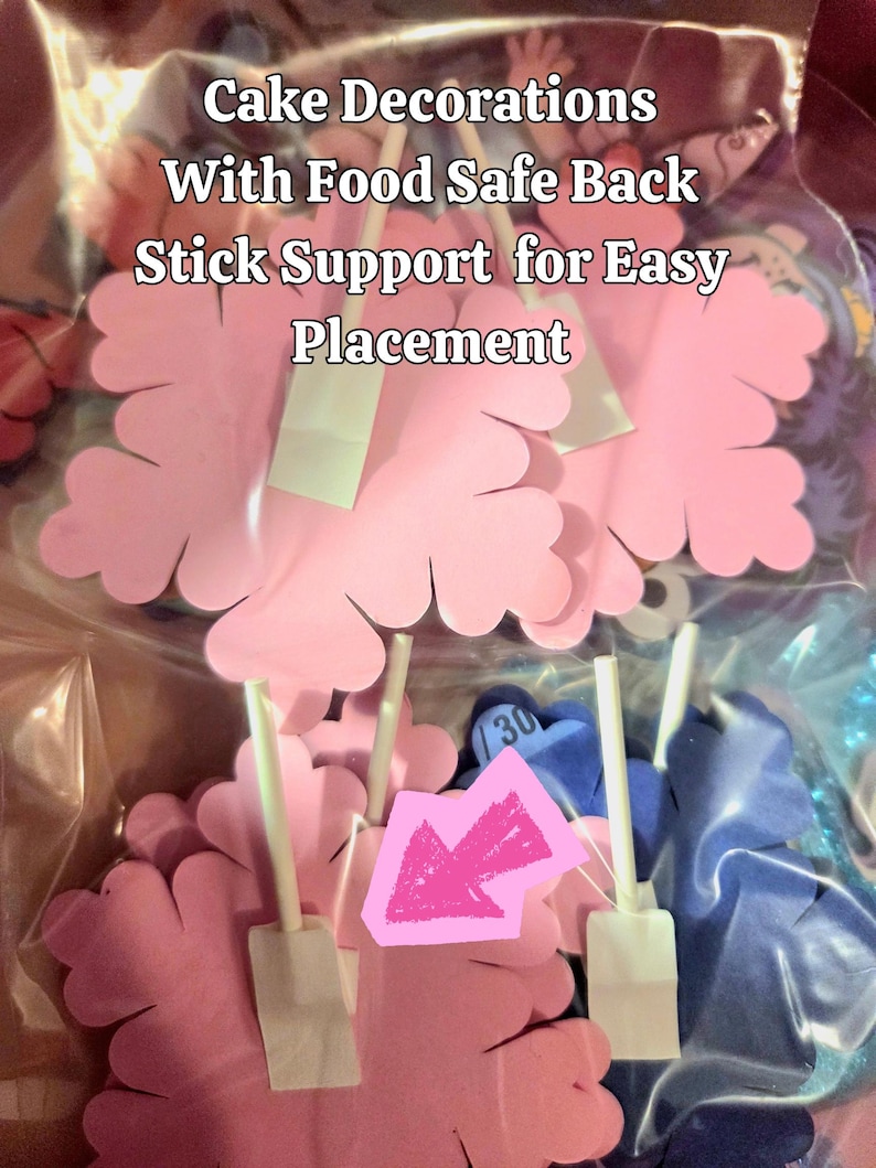 May include: Pink flower-shaped cake decorations with food-safe stick supports for easy placement. The image shows several pink flower decorations with white stick supports, and the text "Cake Decorations With Food Safe Back Stick Support for Easy Placement".