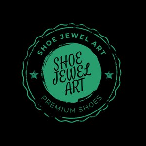 May include: A circular logo with the text "SHOE JEWEL ART" in a green, distressed font. The logo is set against a black background and includes the words "PREMIUM SHOES". Two small stars flank the central text.