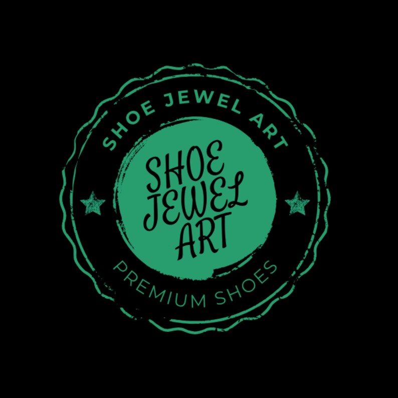 May include: A circular logo with the text "SHOE JEWEL ART" in a green, distressed font. The logo is set against a black background and includes the words "PREMIUM SHOES". Two small stars flank the central text.