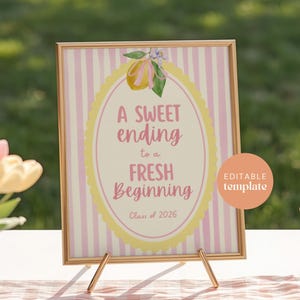May include: A framed sign with a gold border and a pink and white striped background. The sign features the text "A Sweet Ending to a Fresh Beginning" in pink script, with "Class of 2026" below. A peach-colored circle with "Editable Template" is in the lower right.