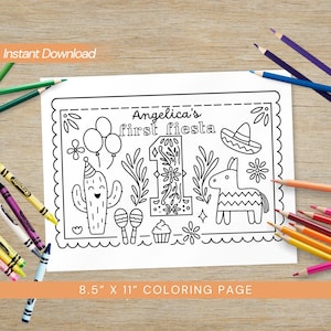May include: Black and white coloring page with the text "Angelica's first fiesta" and festive illustrations, including a cactus, balloons, and a piñata. The page measures 21.6 cm x 27.9 cm and is surrounded by coloured pencils.
