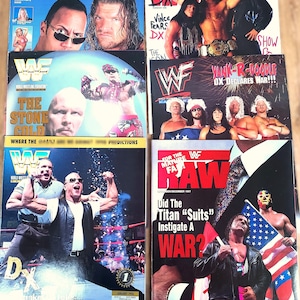 May include: A collection of vintage World Wrestling Federation (WWF) magazines. The covers feature wrestlers like The Rock, Triple H, and Stone Cold Steve Austin. Magazine titles include "Best of 2000" and "RAW".