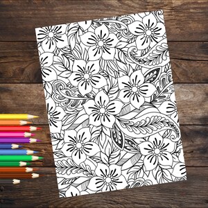 May include: A black and white coloring page featuring a floral pattern with intricate details. The design includes flowers, leaves, and swirls.