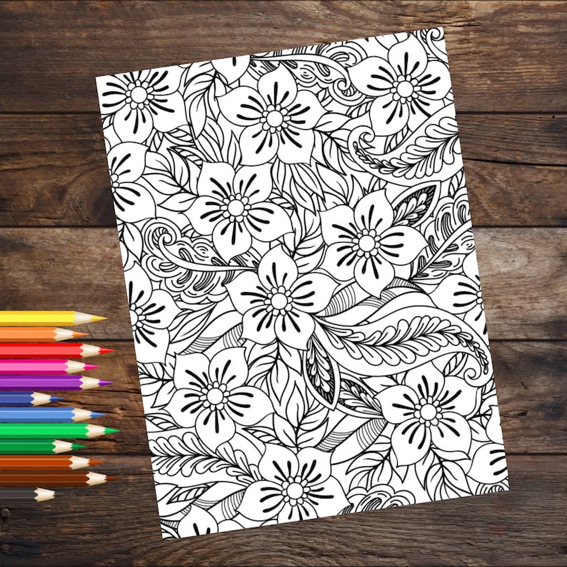 May include: A black and white coloring page featuring a floral pattern with intricate details. The design includes flowers, leaves, and swirls.