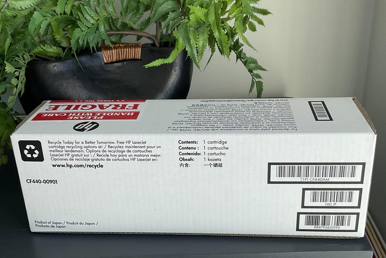 May include: White HP LaserJet printer cartridge box with red "FRAGILE" text. The box includes recycling information and the text "Contents: 1 cartridge". The box also has several barcodes and the product code CF440-00901.