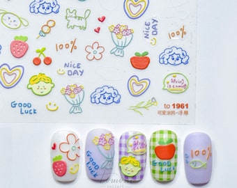 May include: Five purple, white, and green nail tips with different cute cartoon designs. The designs include a flower, a bouquet of flowers, a speech bubble with the text "Spring is coming", an apple, and a fish with the text "100%".