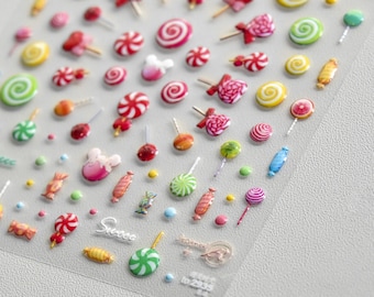 May include: A sheet of colorful candy-themed stickers with various shapes and designs, including lollipops, candy canes, and gumdrops. The stickers are on a clear plastic sheet with the word "Sweet" printed on it.