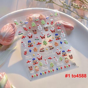 May include: A sheet of Christmas-themed stickers featuring a variety of festive designs, including Santa Claus, reindeer, Christmas trees, and ornaments. The stickers are silver, red, green, and blue. The sheet also includes the text "Merry Christmas".